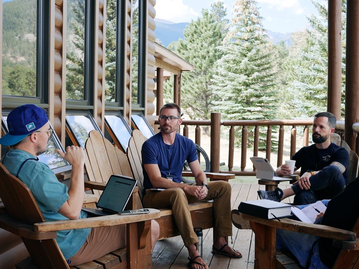 A small group of brothers on the porch at Estes Park